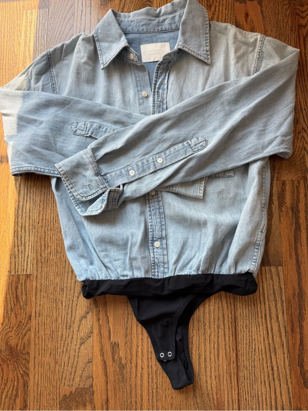 Citizens Of Humanity Light Wash Denim Button-Down Bodysuit with Black Snap Hem